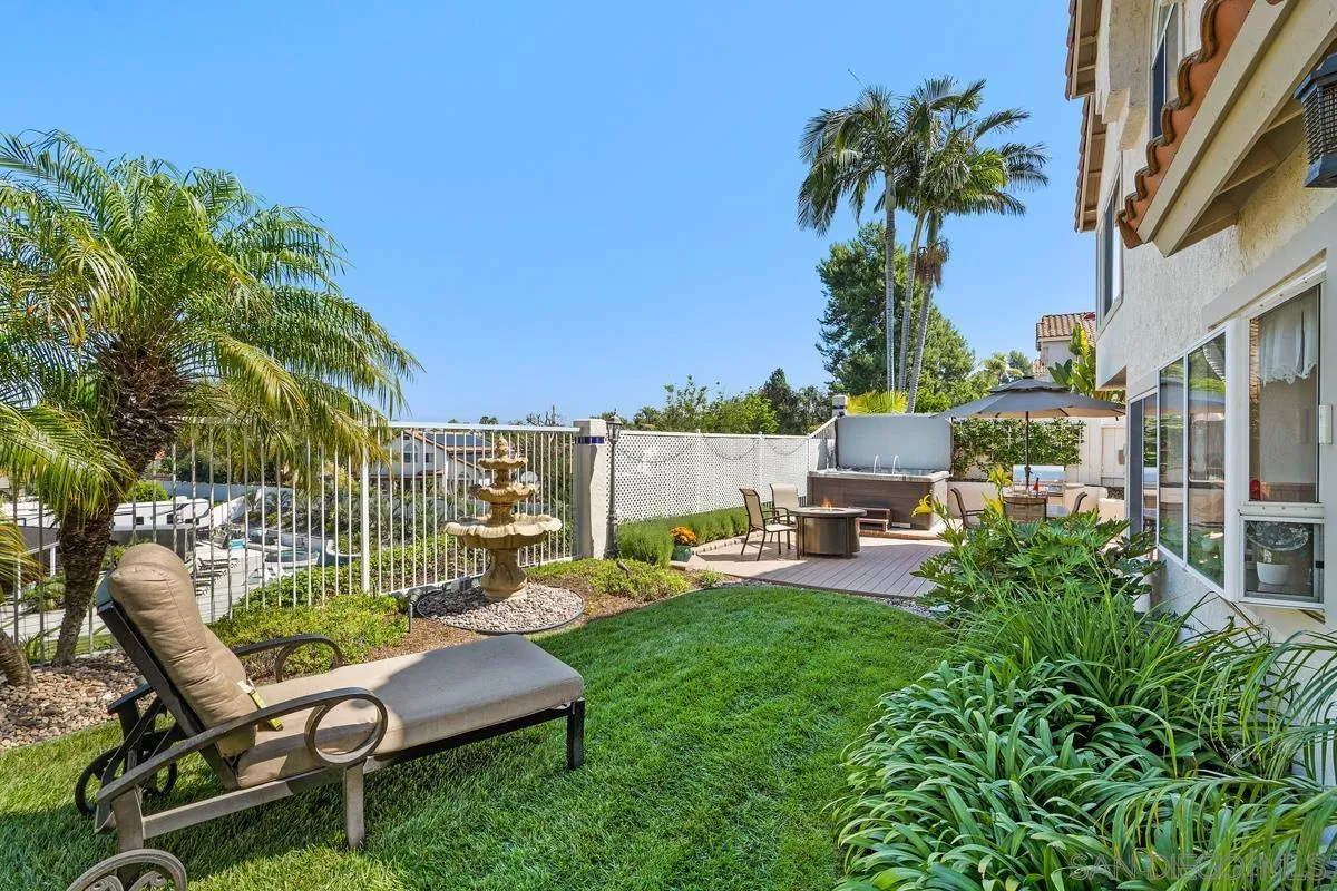 649 Montage Road Oceanside, CA 92057 - Photo 2 of 26 a view of a patio with couches chairs and a table and chairs with palm trees