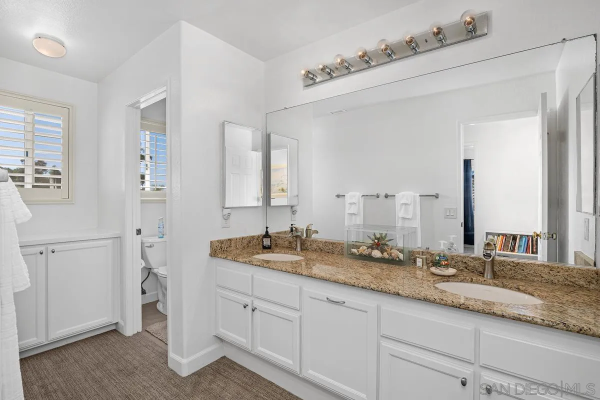 649 Montage Road Oceanside, CA 92057 - Photo 21 of 26 a spacious bathroom with a granite countertop double vanity sink mirror and