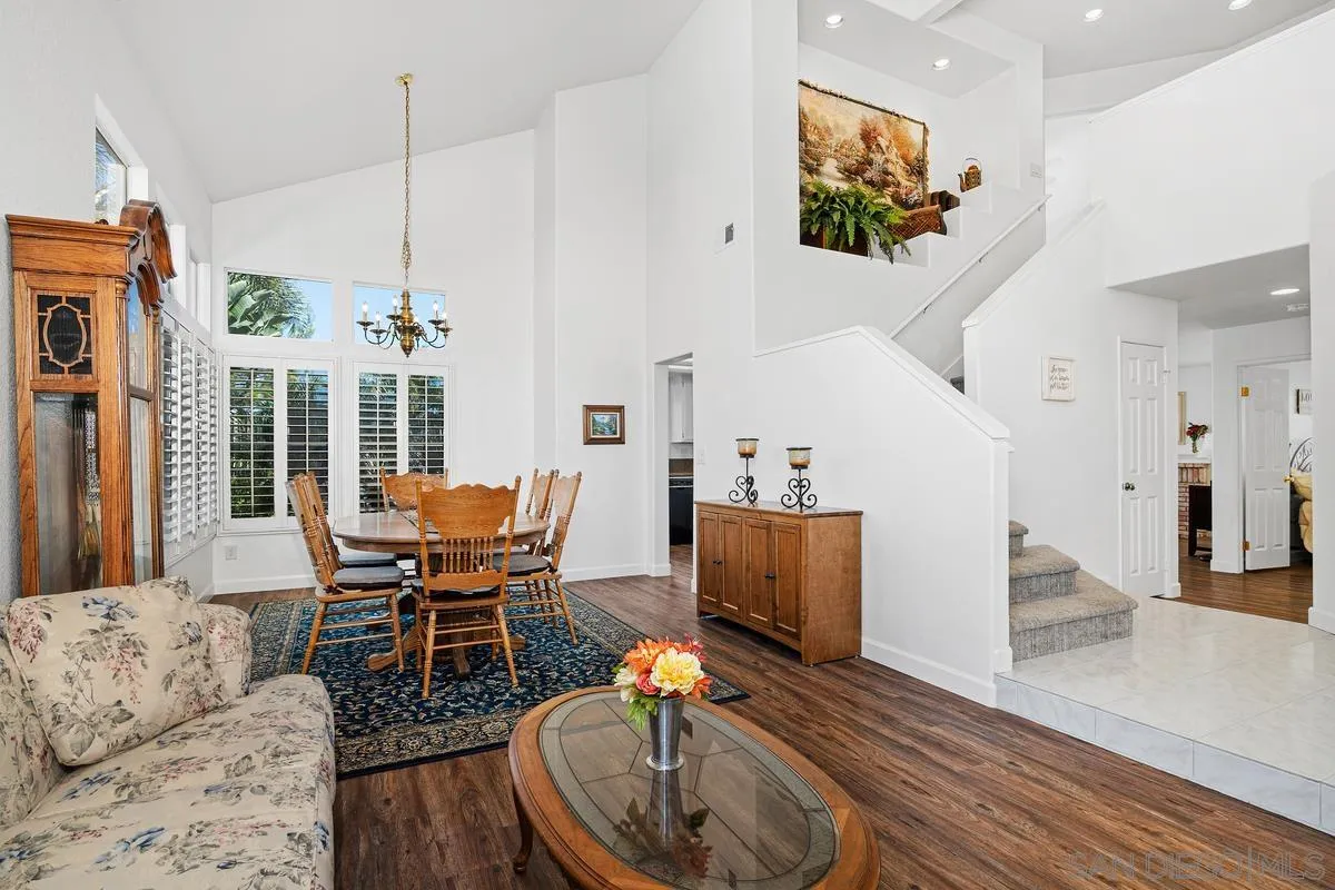 649 Montage Road Oceanside, CA 92057 - Photo 3 of 26 a dining room with furniture a chandelier and wooden floor