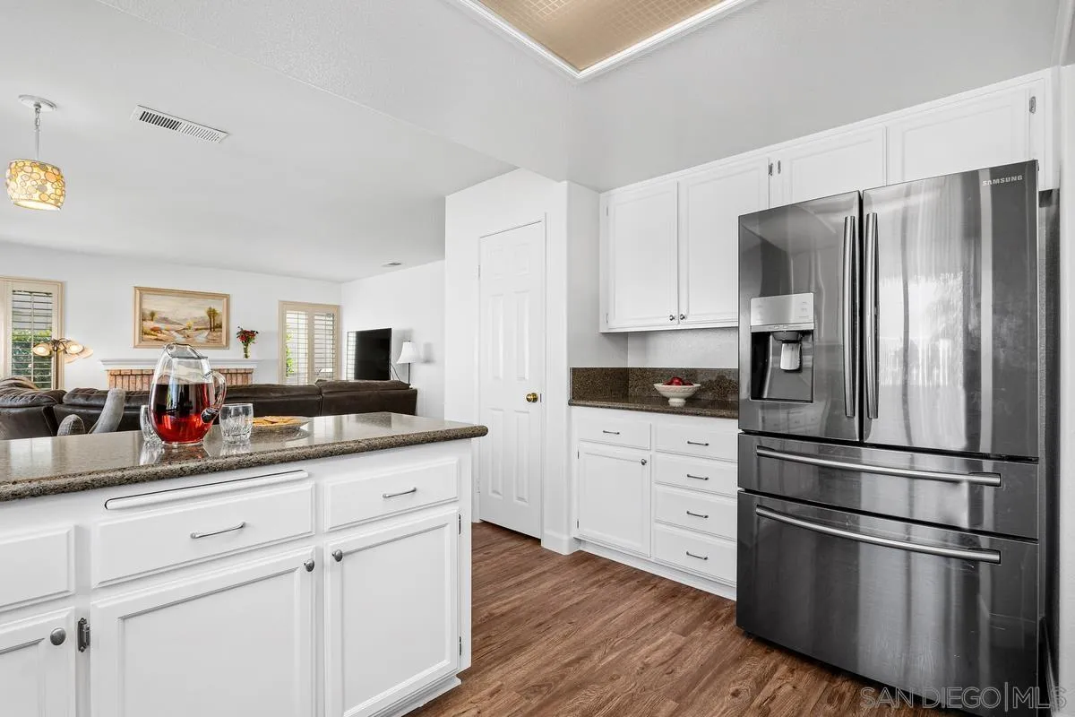 649 Montage Road Oceanside, CA 92057 - Photo 10 of 26 a kitchen with stainless steel appliances white cabinets and a refrigerator