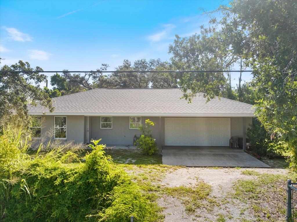 8915 Vamo Road Sarasota, FL 34231 - Photo 12 of 61 a front view of a house with a yard