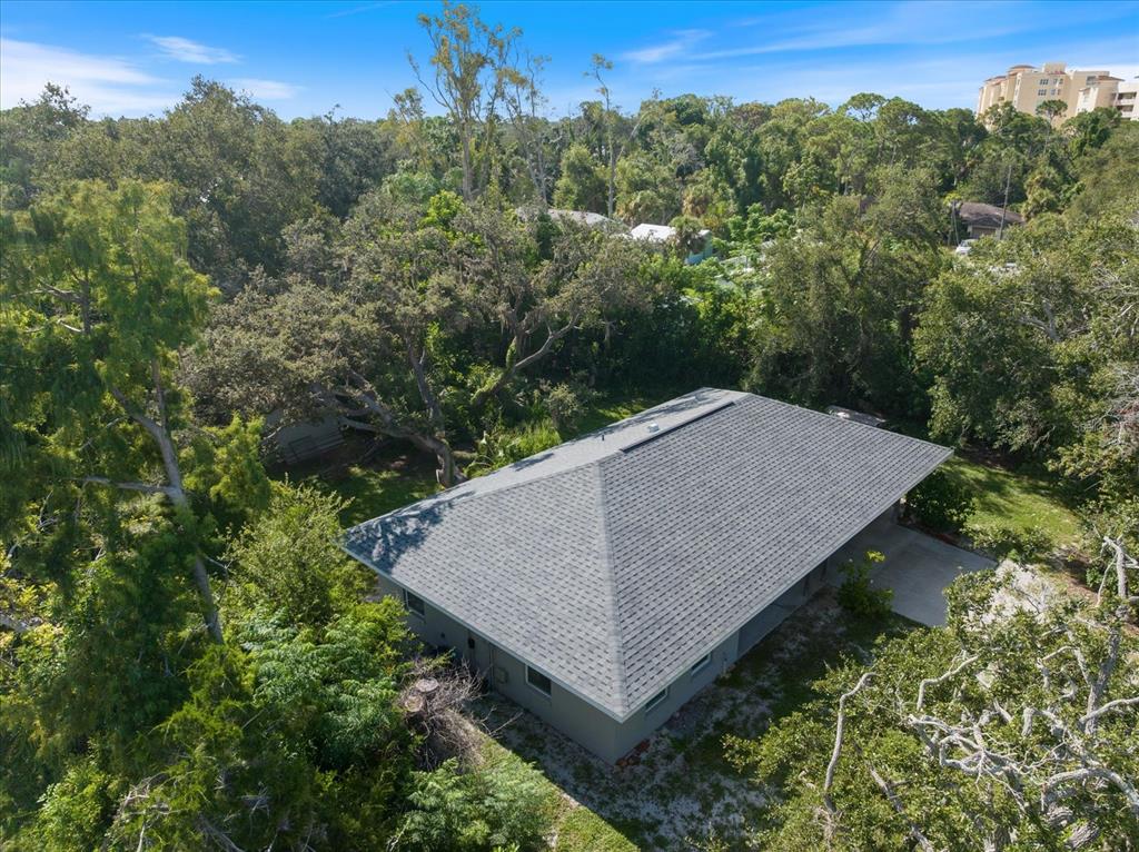 8915 Vamo Road Sarasota, FL 34231 - Photo 15 of 61 an aerial view of a house around side of green forest