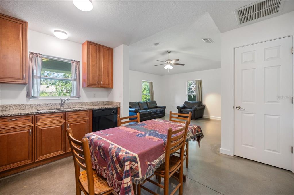 8915 Vamo Road Sarasota, FL 34231 - Photo 27 of 61 a kitchen that has a table and chairs in it