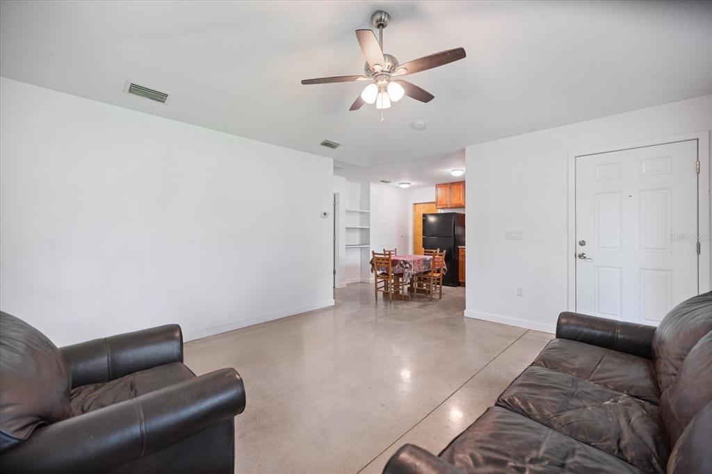 8915 Vamo Road Sarasota, FL 34231 - Photo 32 of 61 a living room with furniture and a chandelier