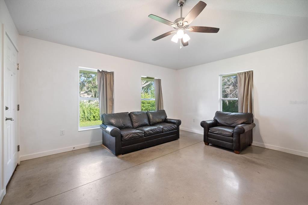 8915 Vamo Road Sarasota, FL 34231 - Photo 34 of 61 a living room with furniture and a window