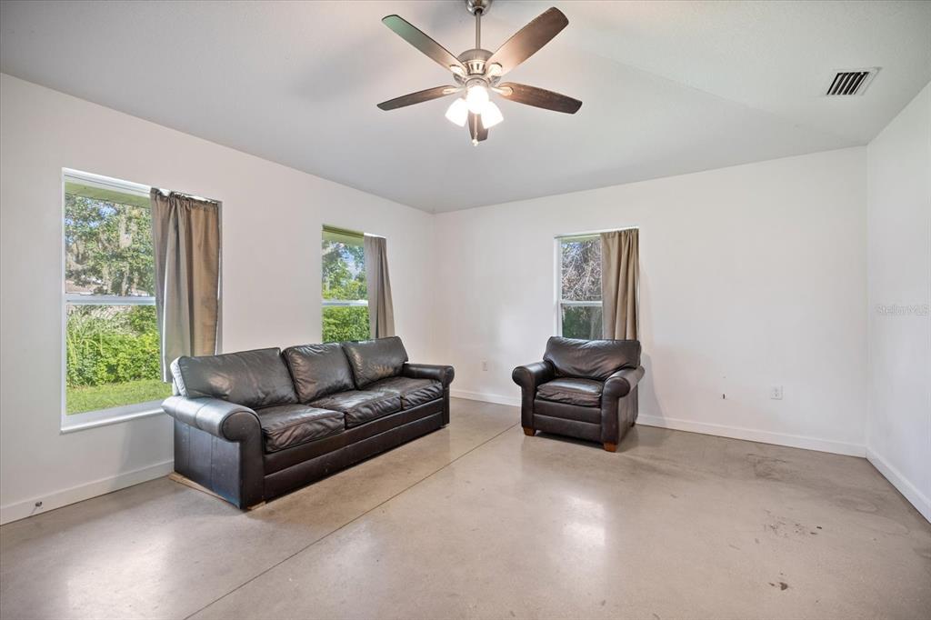 8915 Vamo Road Sarasota, FL 34231 - Photo 35 of 61 a living room with furniture and a window
