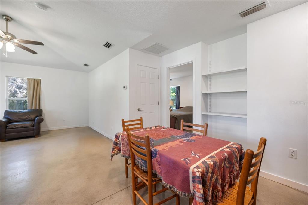 8915 Vamo Road Sarasota, FL 34231 - Photo 36 of 61 a bedroom with a bed and a table in it