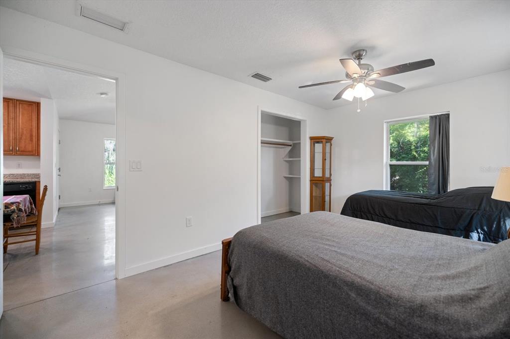 8915 Vamo Road Sarasota, FL 34231 - Photo 38 of 61 a bedroom with a bed and a chandelier