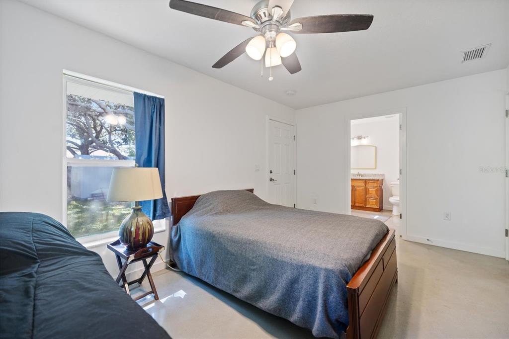 8915 Vamo Road Sarasota, FL 34231 - Photo 39 of 61 a bedroom with a bed and a chandelier