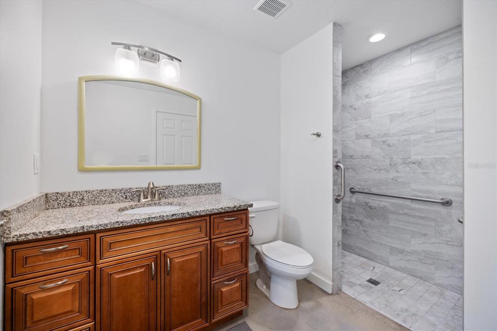 8915 Vamo Road Sarasota, FL 34231 - Photo 41 of 61 a bathroom with a granite countertop sink toilet and shower