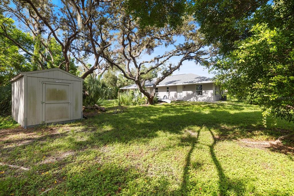 8915 Vamo Road Sarasota, FL 34231 - Photo 51 of 61 a view of an house with backyard space and tree