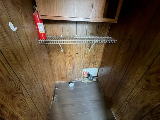 a view of small space with wooden floors and dryer
