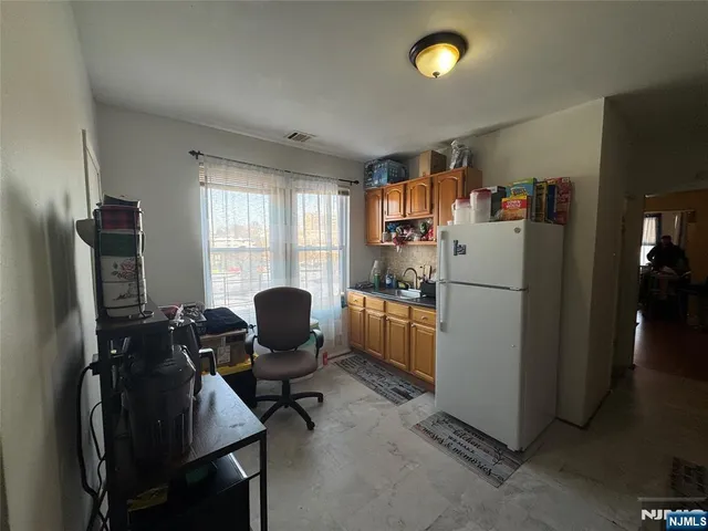 a view of a workspace with furniture and a window