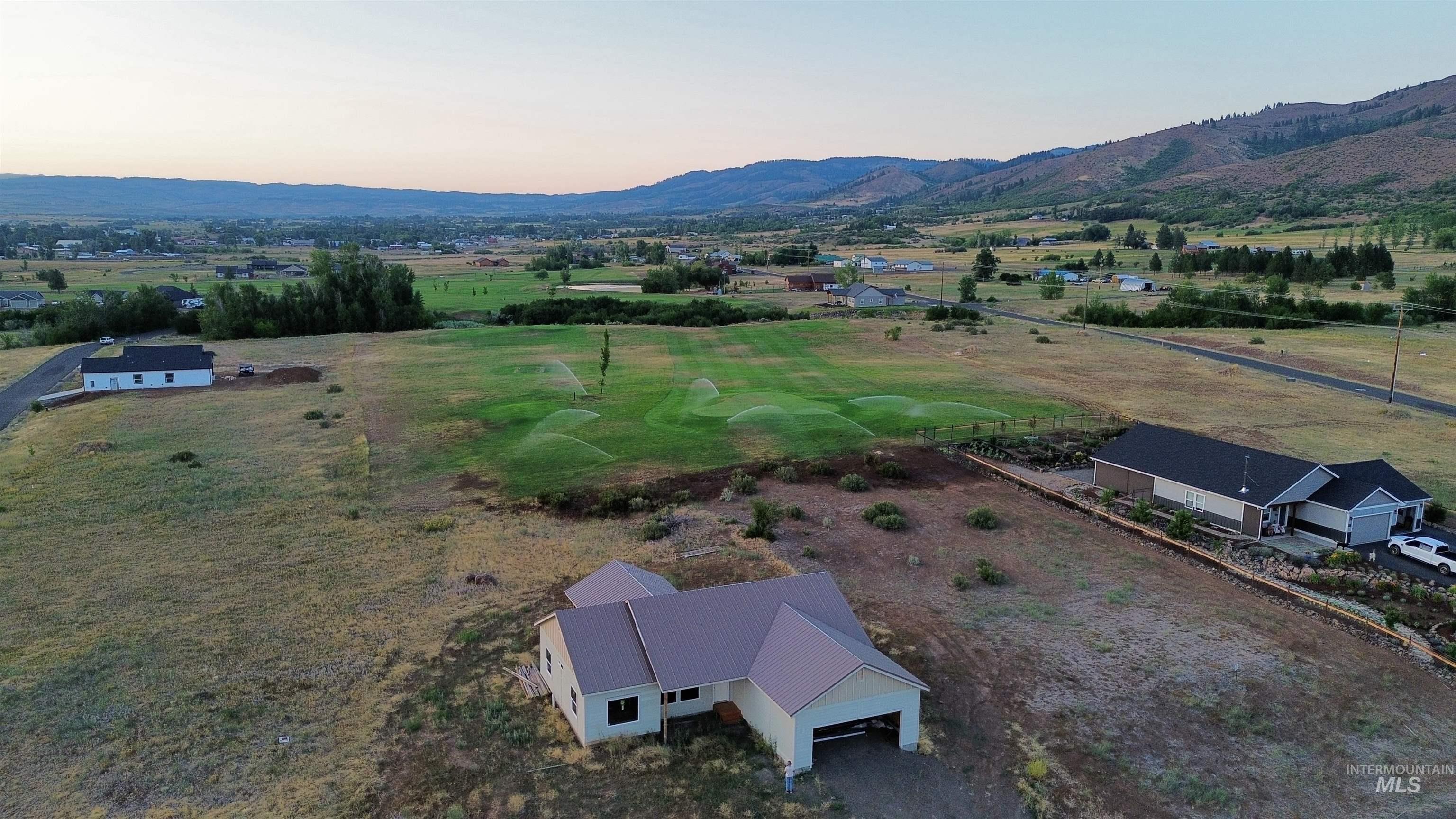 2300 Golf Council, ID 83612 - Photo 4 of 17 Aerial view at dusk of a mountain view and a view of rural / pastoral area