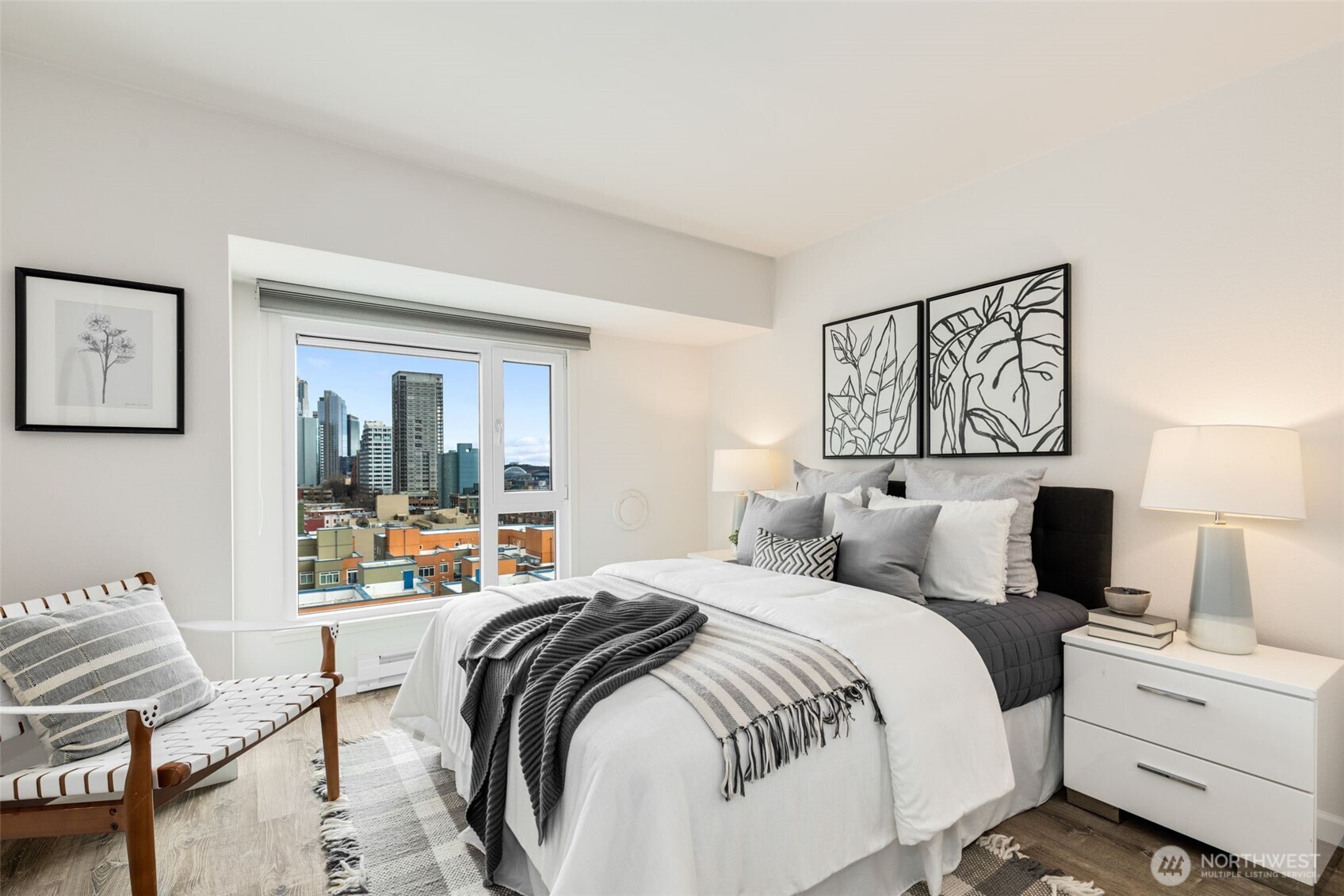 121 Vine Street, Unit 1507 Seattle, WA 98121 - Photo 14 of 40 a bedroom with a bed and wooden floor