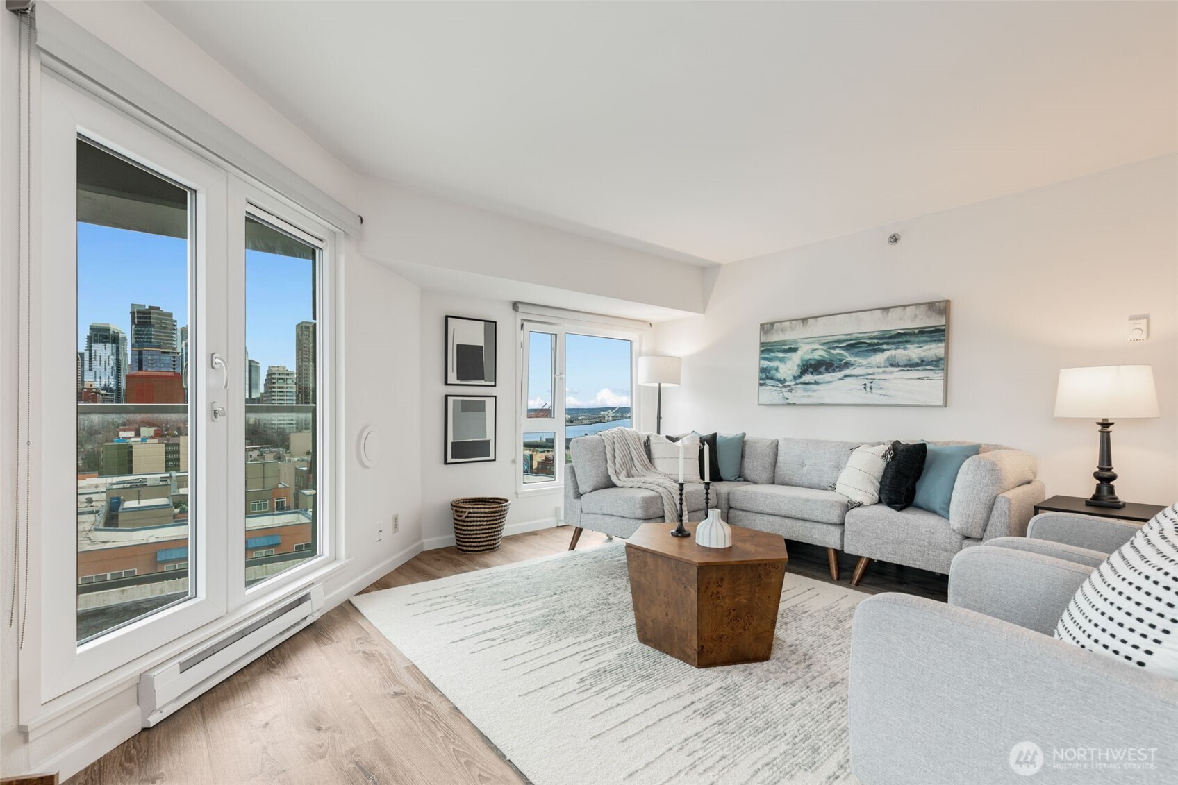121 Vine Street, Unit 1507 Seattle, WA 98121 - Photo 18 of 40 a living room with furniture wooden floor and a lamp