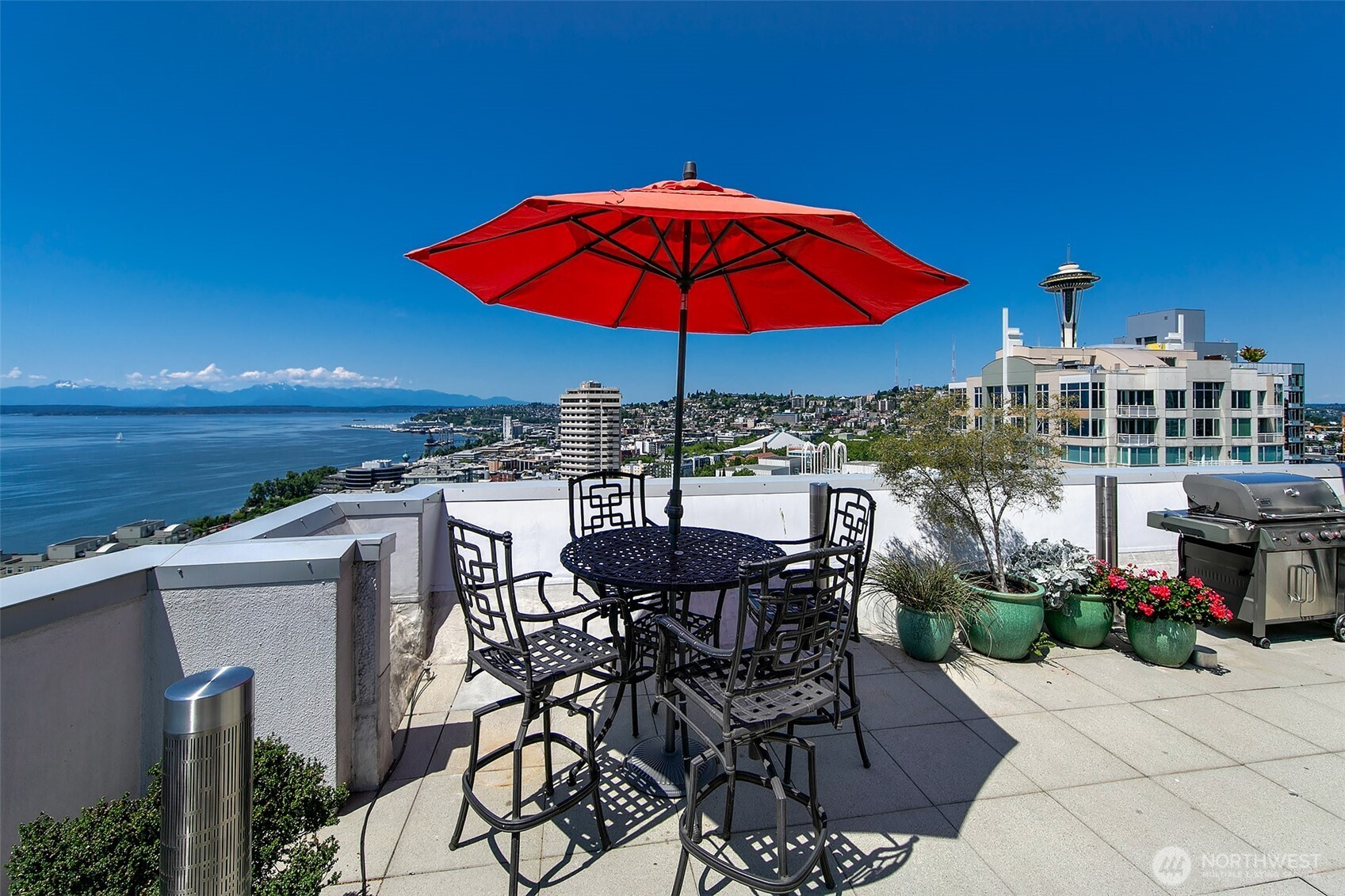 121 Vine Street, Unit 1507 Seattle, WA 98121 - Photo 26 of 40 a view of a terrace with furniture and umbrella