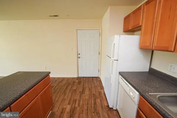 a kitchen with a sink and a refrigerator