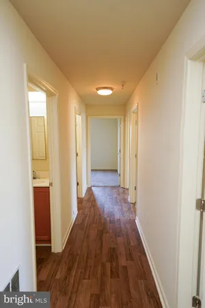 a view of hallway with wooden floor