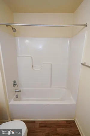 a bathroom with a bathtub and a toilet