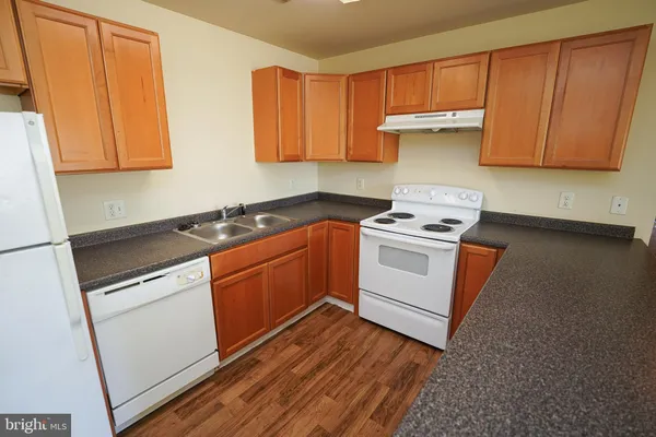 a kitchen with stainless steel appliances a stove a microwave and a white cabinets