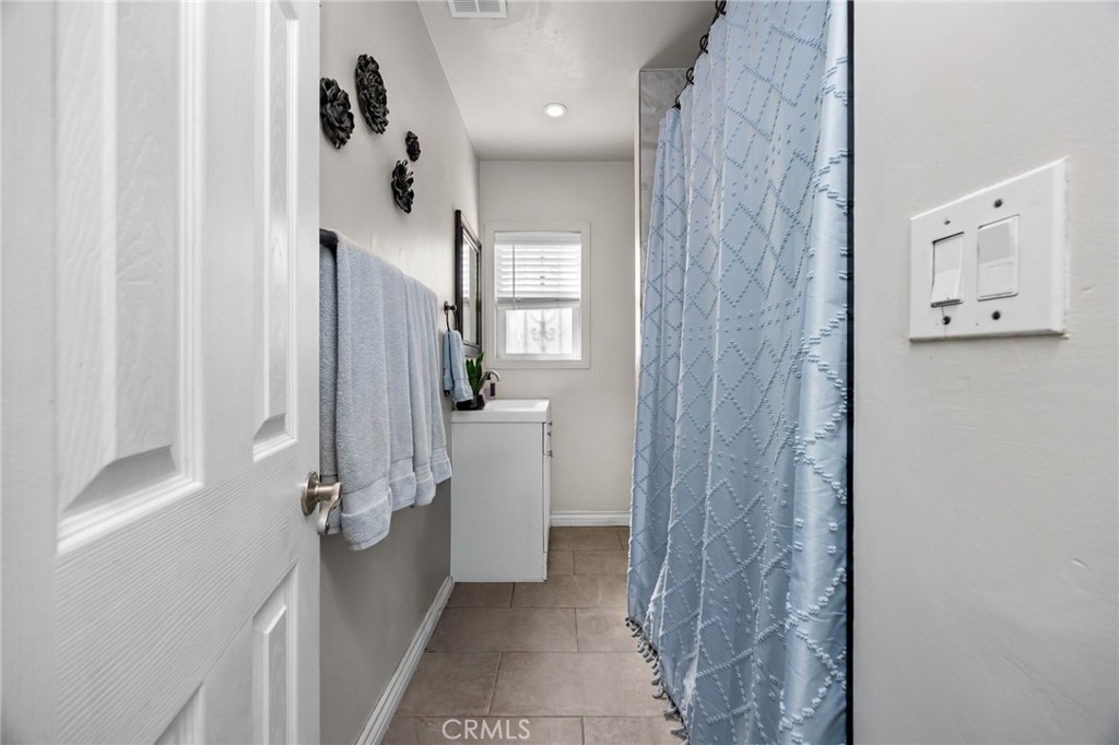 435 East Adams Street Santa Ana, CA 92707 - Photo 14 of 32 a bathroom with a shower and a sink