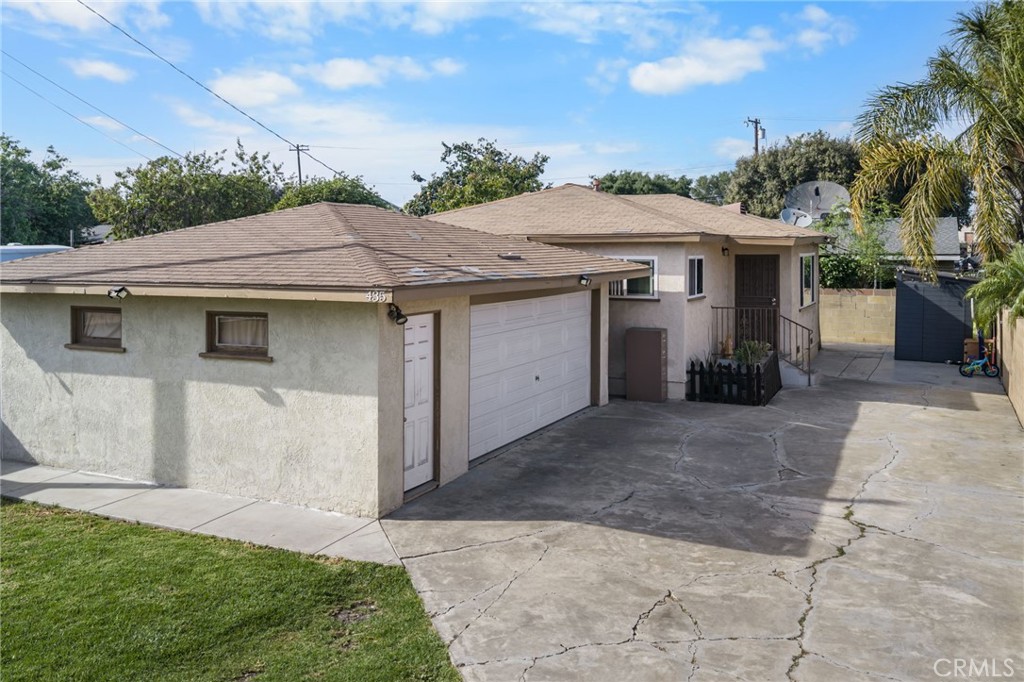 435 East Adams Street Santa Ana, CA 92707 - Photo 2 of 32 a view of a white house with a yard plants and large tree
