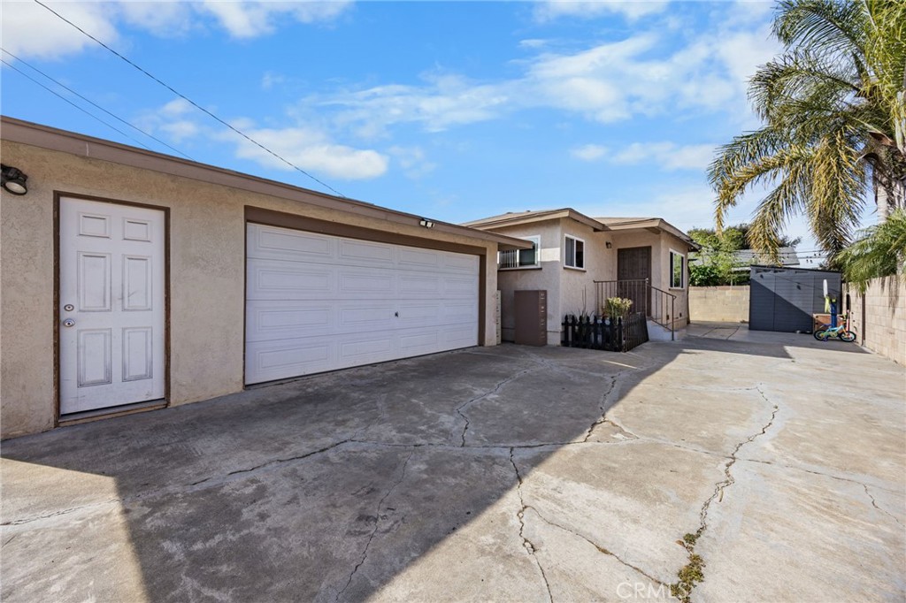 435 East Adams Street Santa Ana, CA 92707 - Photo 21 of 32 a view of a house with a yard and garage