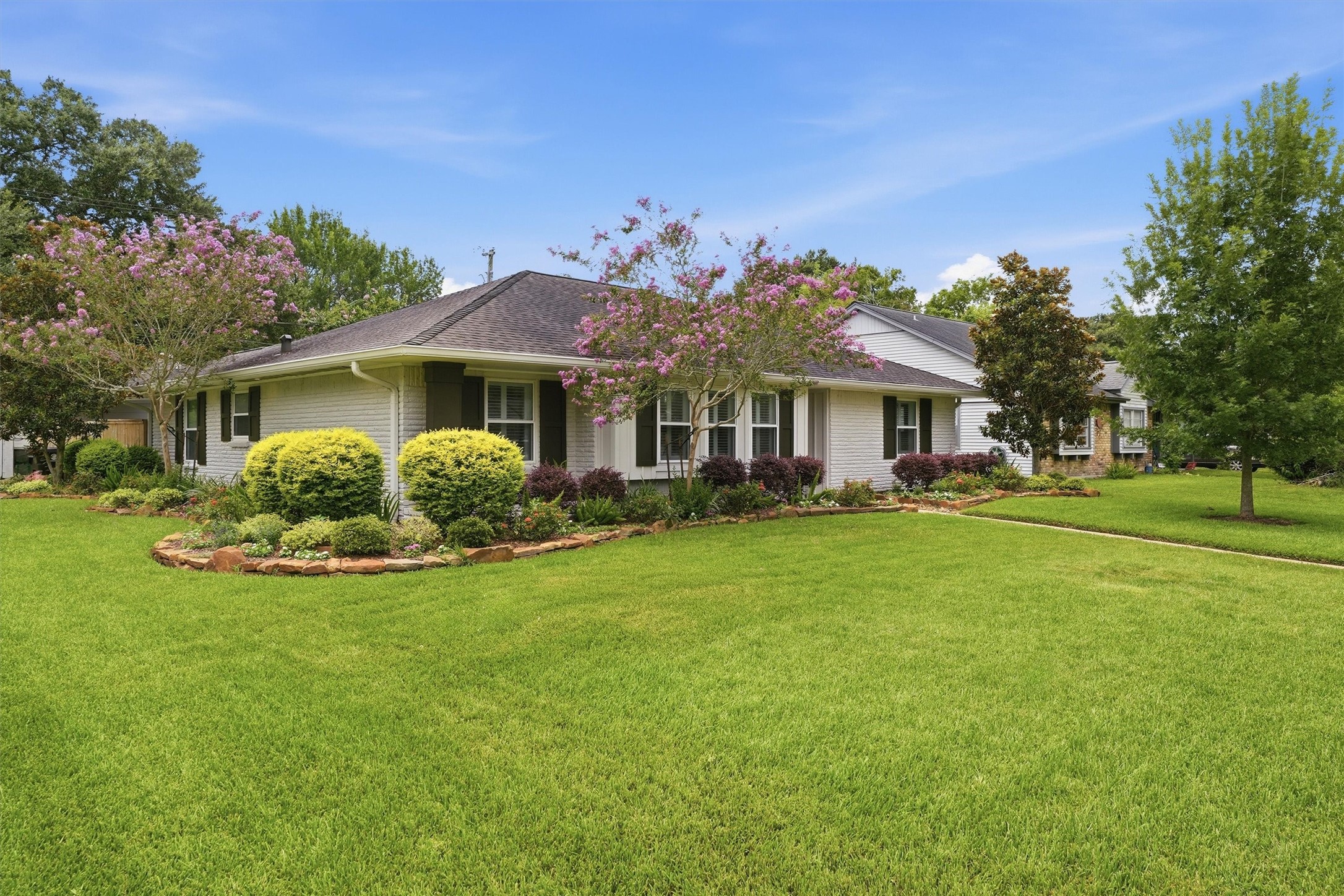 4701 Hummingbird Street Houston, TX 77035 - Photo 2 of 28 Situated on a corner lot with colorful landscaping and blooming trees.