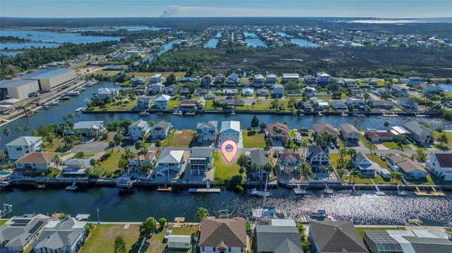 an aerial view of a house with a lake view