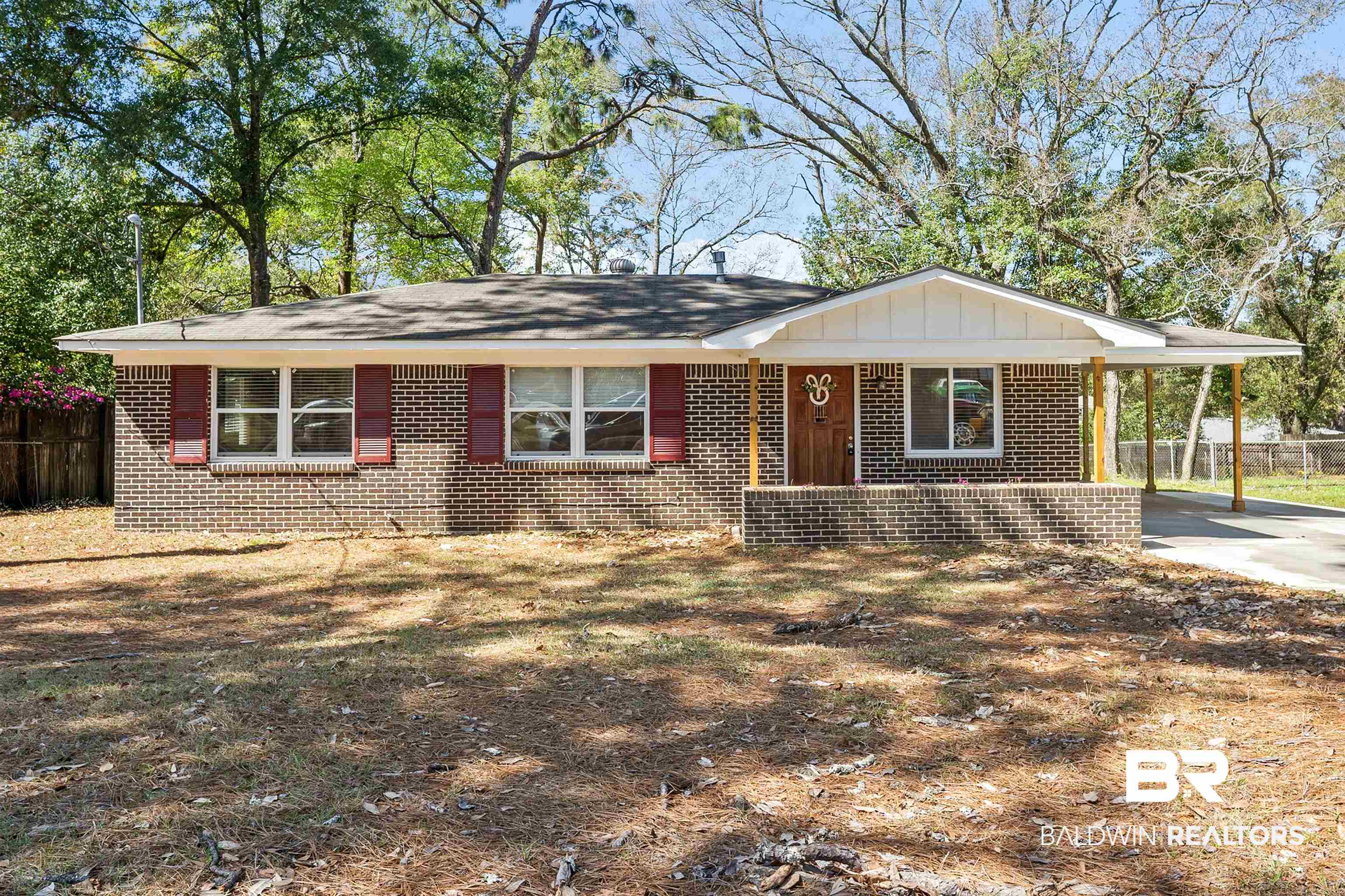 672 Tarawa Drive Mobile, AL 36609 - Photo 1 of 26 View of front of home featuring covered porch, an attached carport, board and batten siding, and brick siding