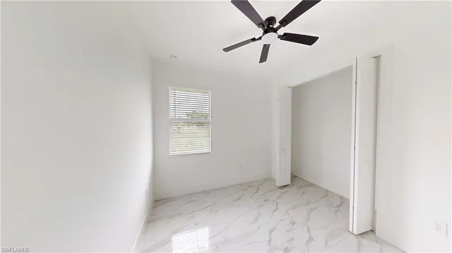 a view of a livingroom with a window and a ceiling fan