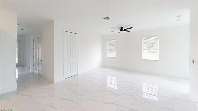 a view of a livingroom with a ceiling fan and window