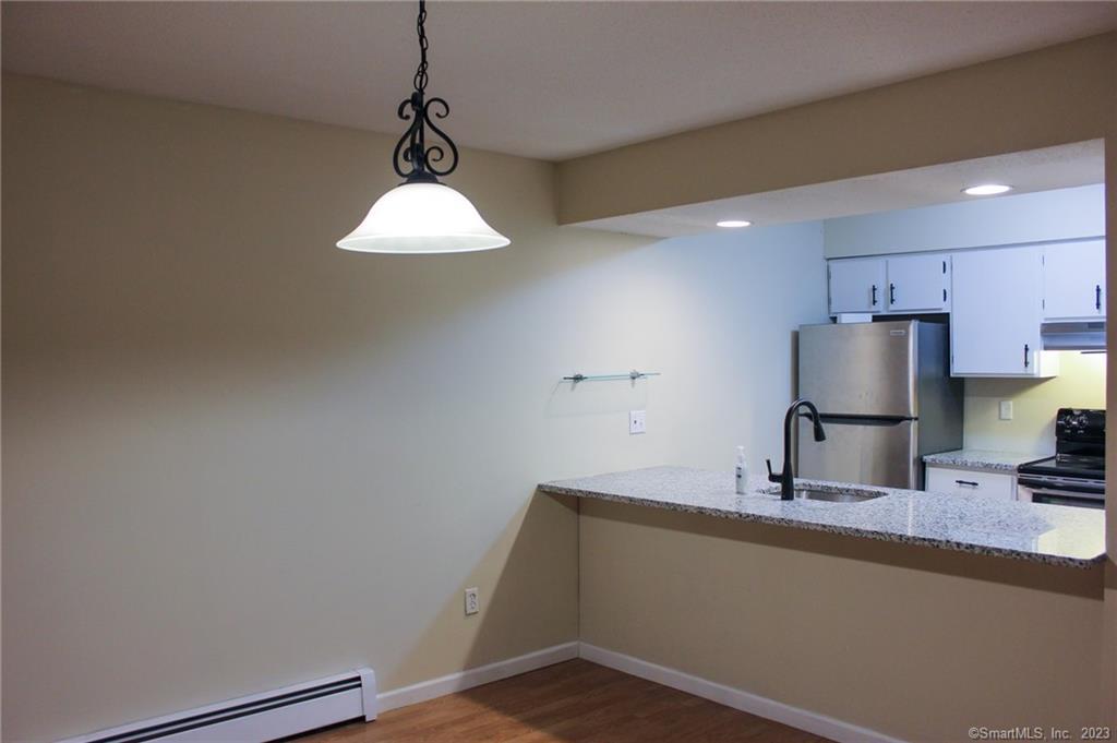 60 Old Town Road, Unit 171 Vernon, CT 06066 - Photo 11 of 30 a kitchen with a sink and a refrigerator