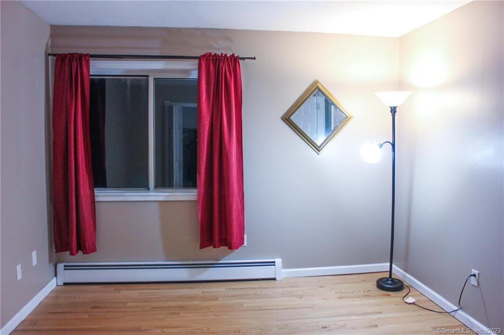 60 Old Town Road, Unit 171 Vernon, CT 06066 - Photo 16 of 30 a view of a living room with a red chair and a wooden floor