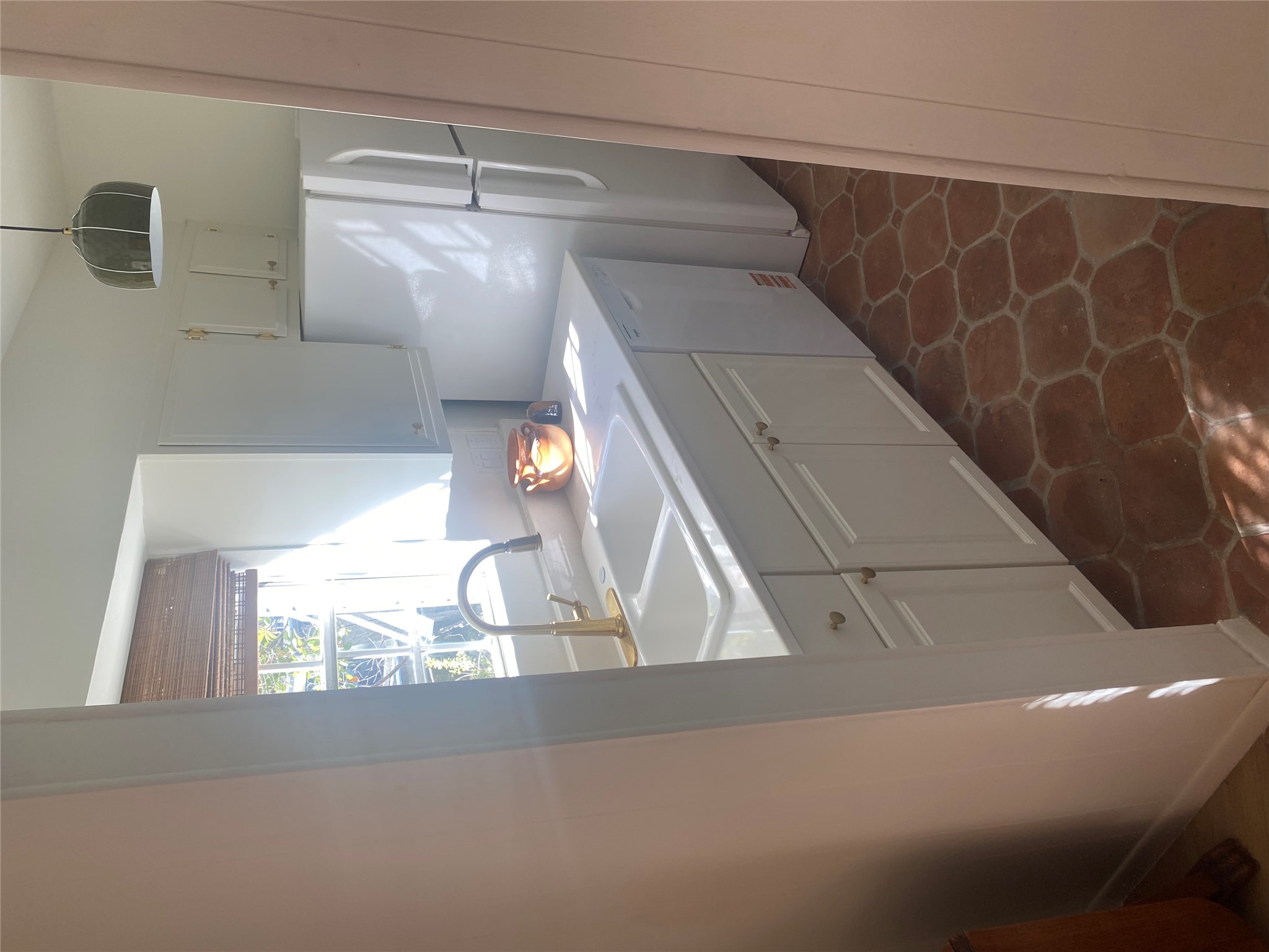 1700 Houston Street, Unit 103 Austin, TX 78756 - Photo 4 of 8 Kitchen with white cabinets, hanging light fixtures, light countertops, and white appliances