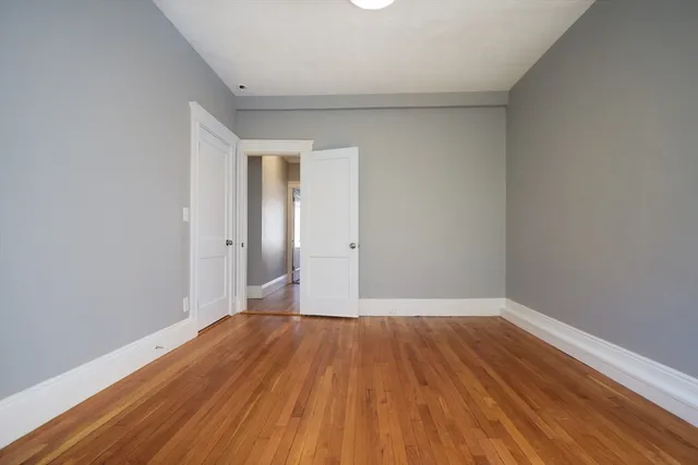 a view of a room with wooden floor and white walls
