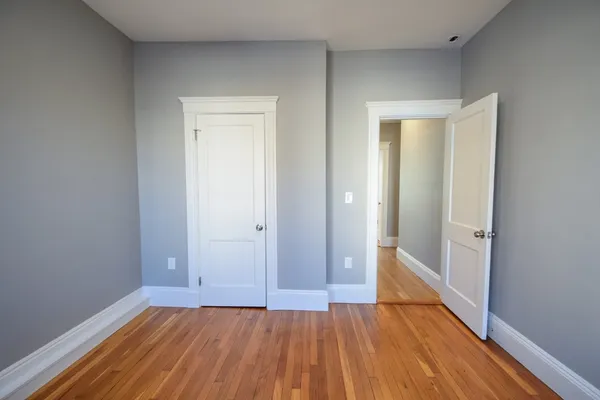 a view of an empty room and wooden floor