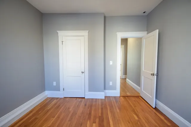 a view of an empty room and wooden floor