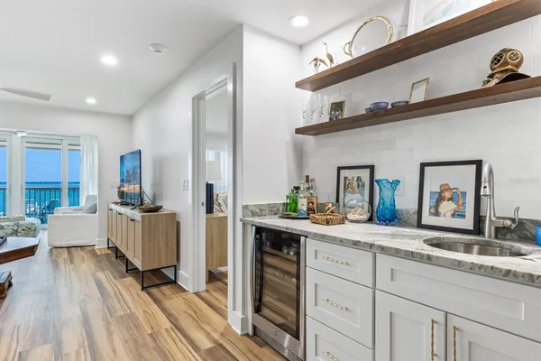 a spacious bathroom with a granite countertop sink mirror and bathtub