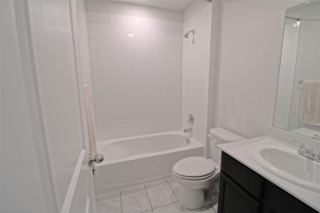 2428 Rosharon Drive Forney, TX 75126 - Photo 14 of 34 a bathroom with a sink toilet and shower