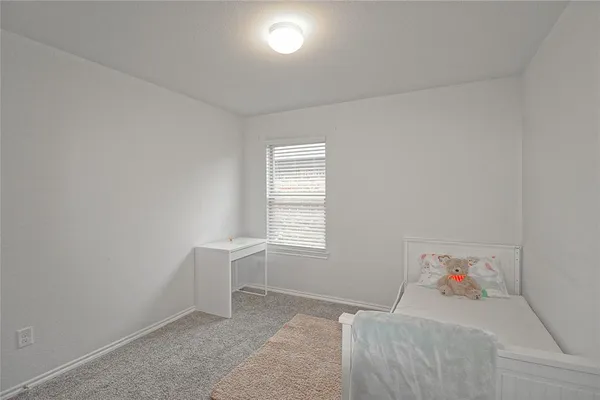 a room with a bed and a window