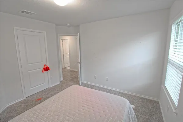 a room that has a bed and a window