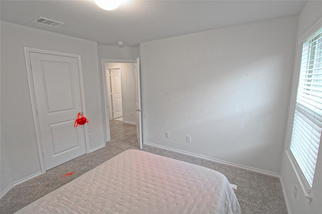 2428 Rosharon Drive Forney, TX 75126 - Photo 18 of 34 a room that has a bed and a window