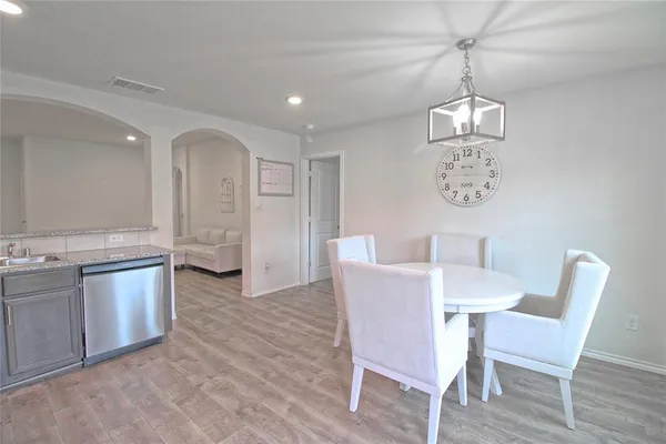 a view of a dining room with furniture and wooden floor