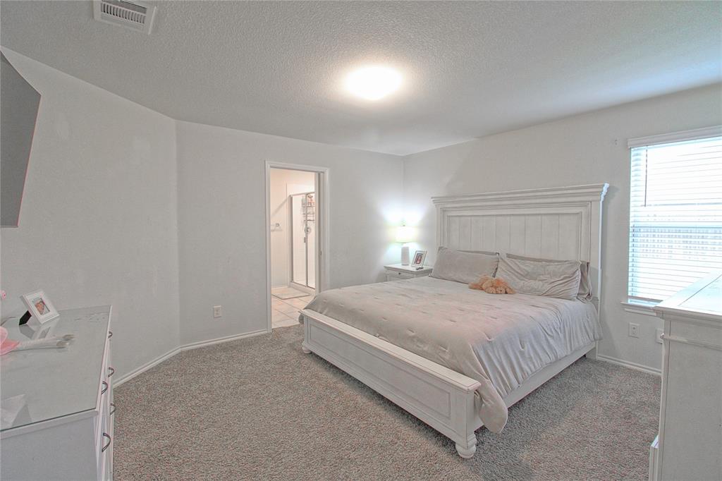 2428 Rosharon Drive Forney, TX 75126 - Photo 22 of 34 a bedroom with a bed and window