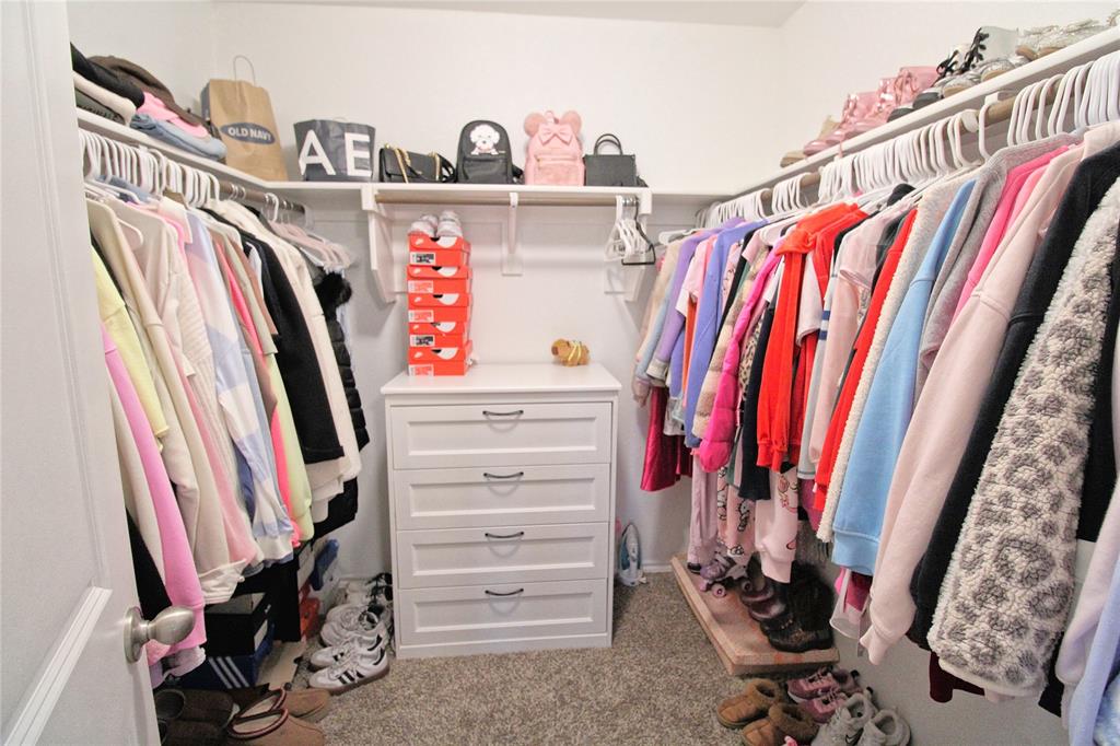 2428 Rosharon Drive Forney, TX 75126 - Photo 24 of 34 a view of walk in closet with clothes and shoes