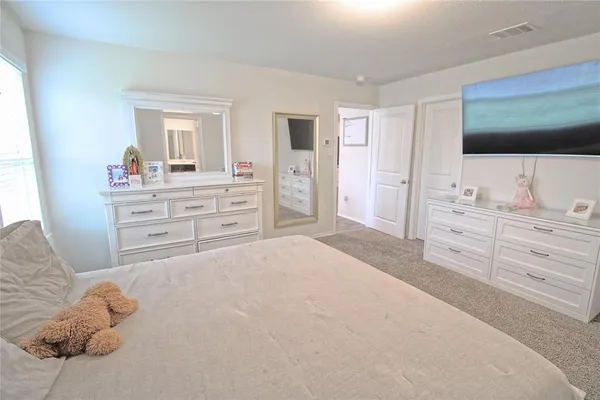 a bedroom with a bed and a flat screen tv in it