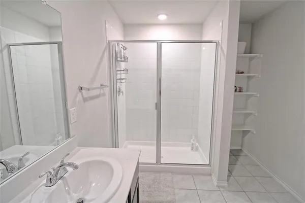 a bathroom with a shower and a sink