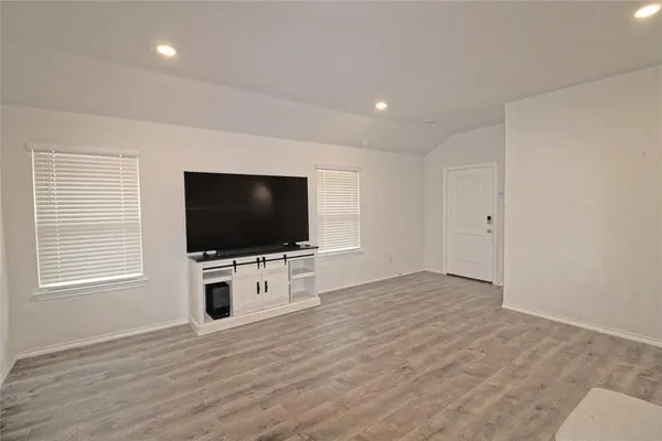 a living room with flat screen tv and a window